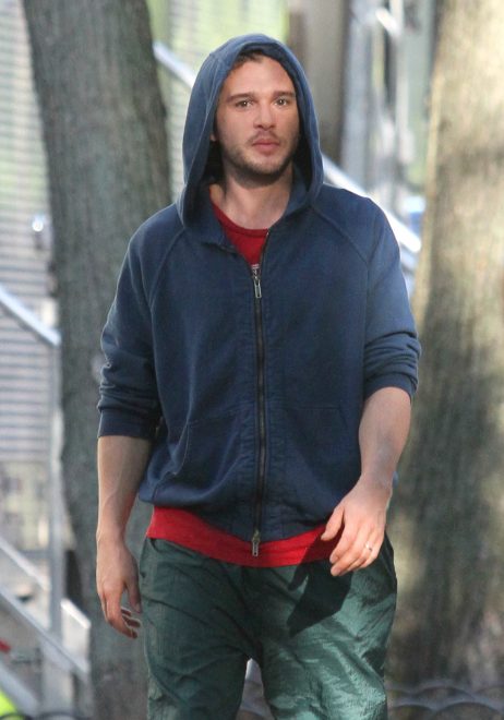 Game of Thrones actor Kit Harington looks like a ninja as he covers his face while on the set of The Death and Life of John F. Donovan