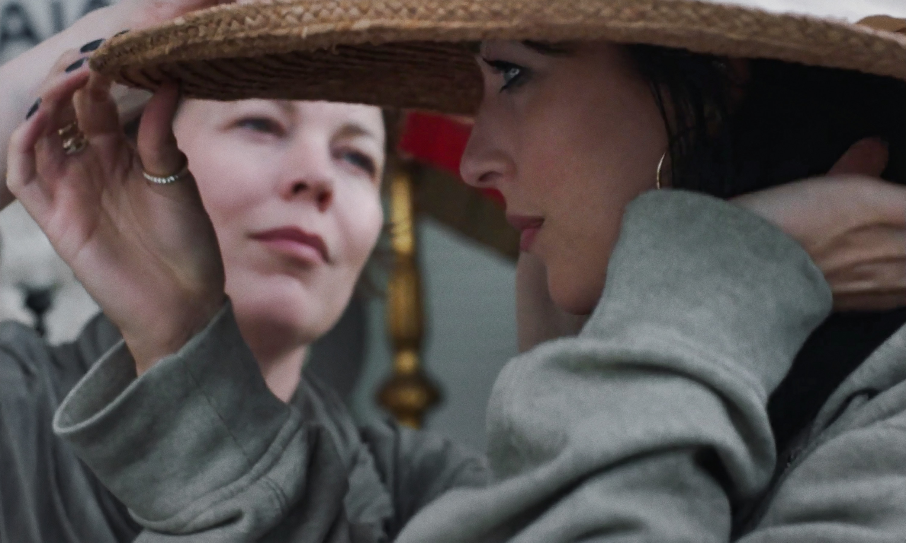 THE LOST DAUGHTER (L to R): OLIVIA COLMAN as LEDA, DAKOTA JOHNSON as NINA. CR: YANNIS DRAKOULIDIS/NETFLIX © 2021. THE LOST DAUGHTER (L to R): OLIVIA COLMAN as LEDA, DAKOTA JOHNSON as NINA. CR: YANNIS DRAKOULIDIS/NETFLIX © 2021.